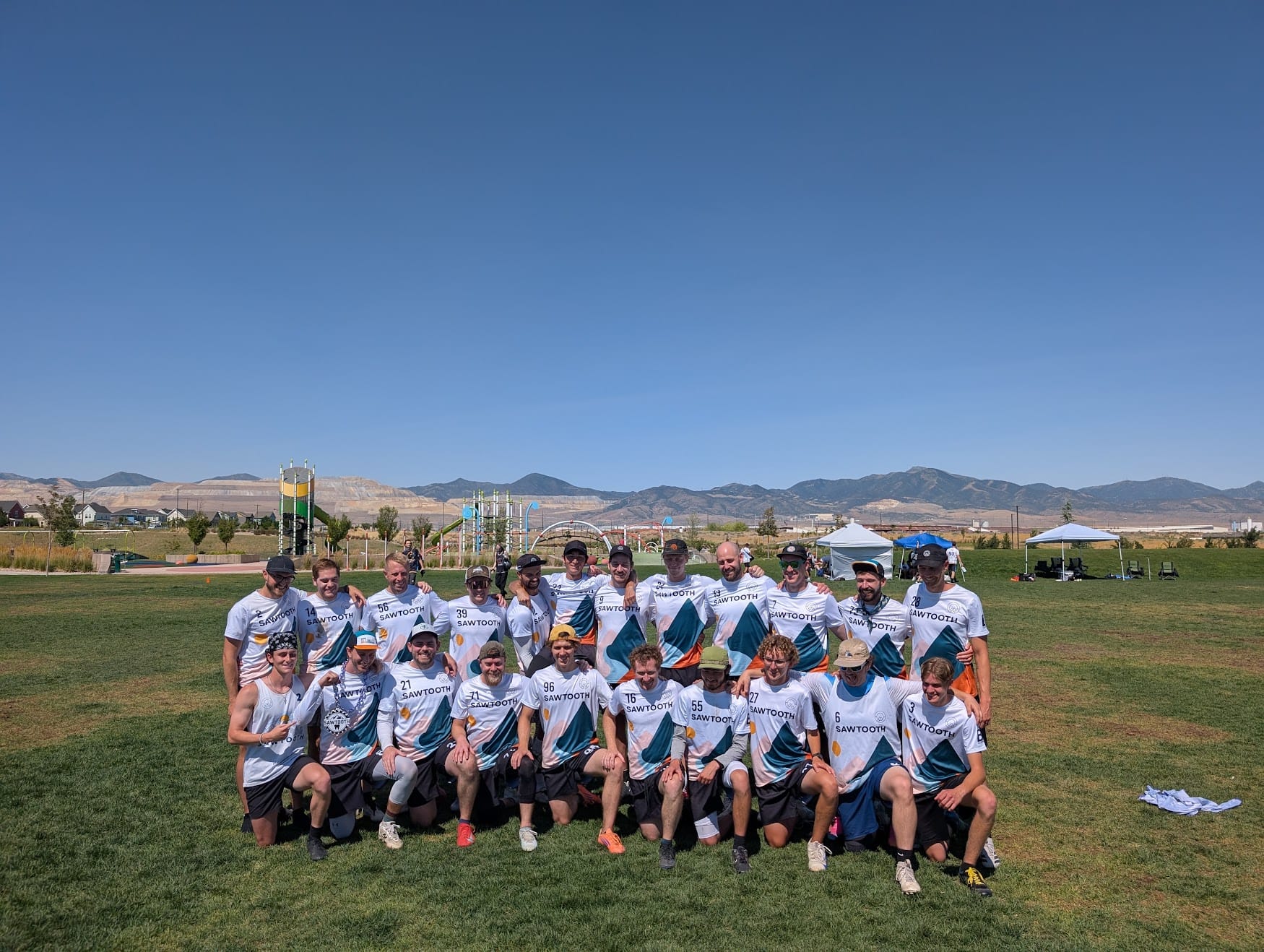 The Sawtooth roster on a park field with the foothills behind them.